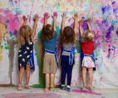 Group of children celebrating their artwork at Artnest Studio