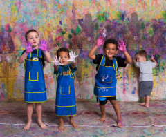 Family posing with their art creations at Artnest Studio